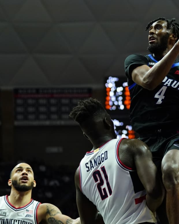 Mar 5, 2022; Storrs, Connecticut, USA; DePaul Blue Demons guard Javon Freeman-Liberty (4) drives the ball over Connecticut Huskies forward Adama Sanogo (21) in the second half at Harry A. Gampel Pavilion. Mandatory Credit: David Butler II-USA TODAY Sports